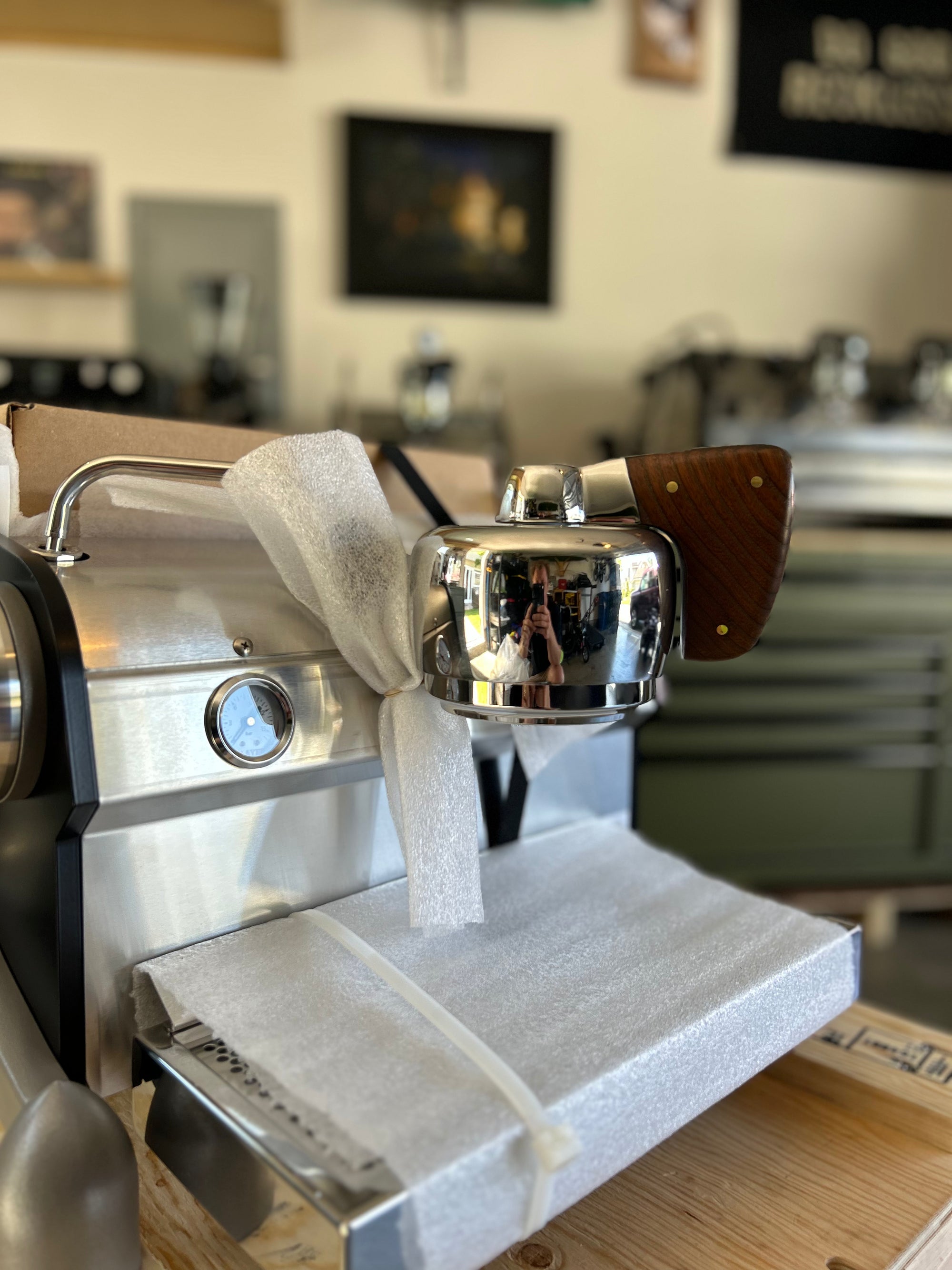 Slayer Espresso Single Espresso machine with a towel draped over it in a kitchen setting