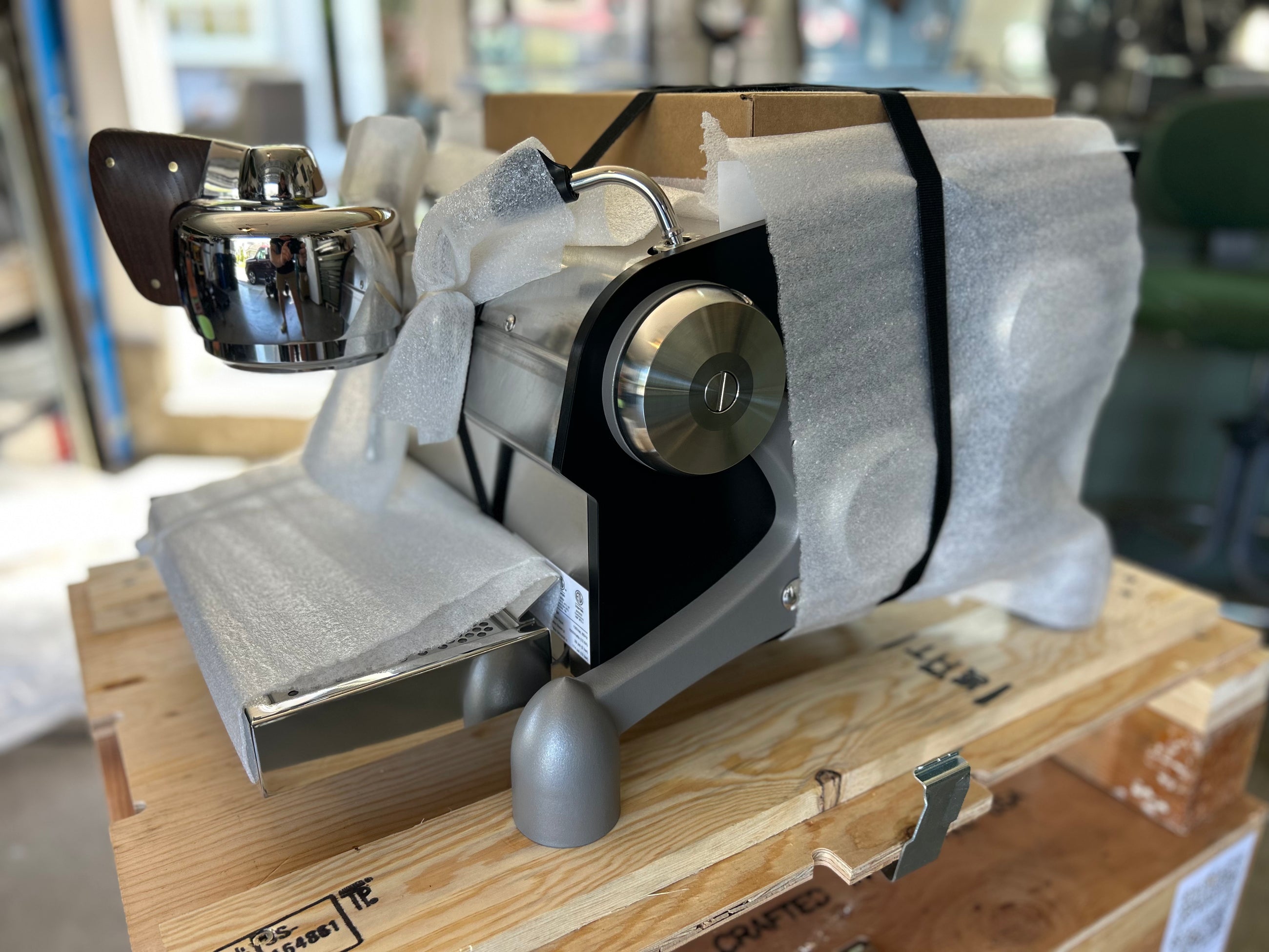 Slayer Espresso Single in packaging on a wooden pallet