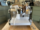 Slayer Espresso Single on a wooden counter with a blurred background