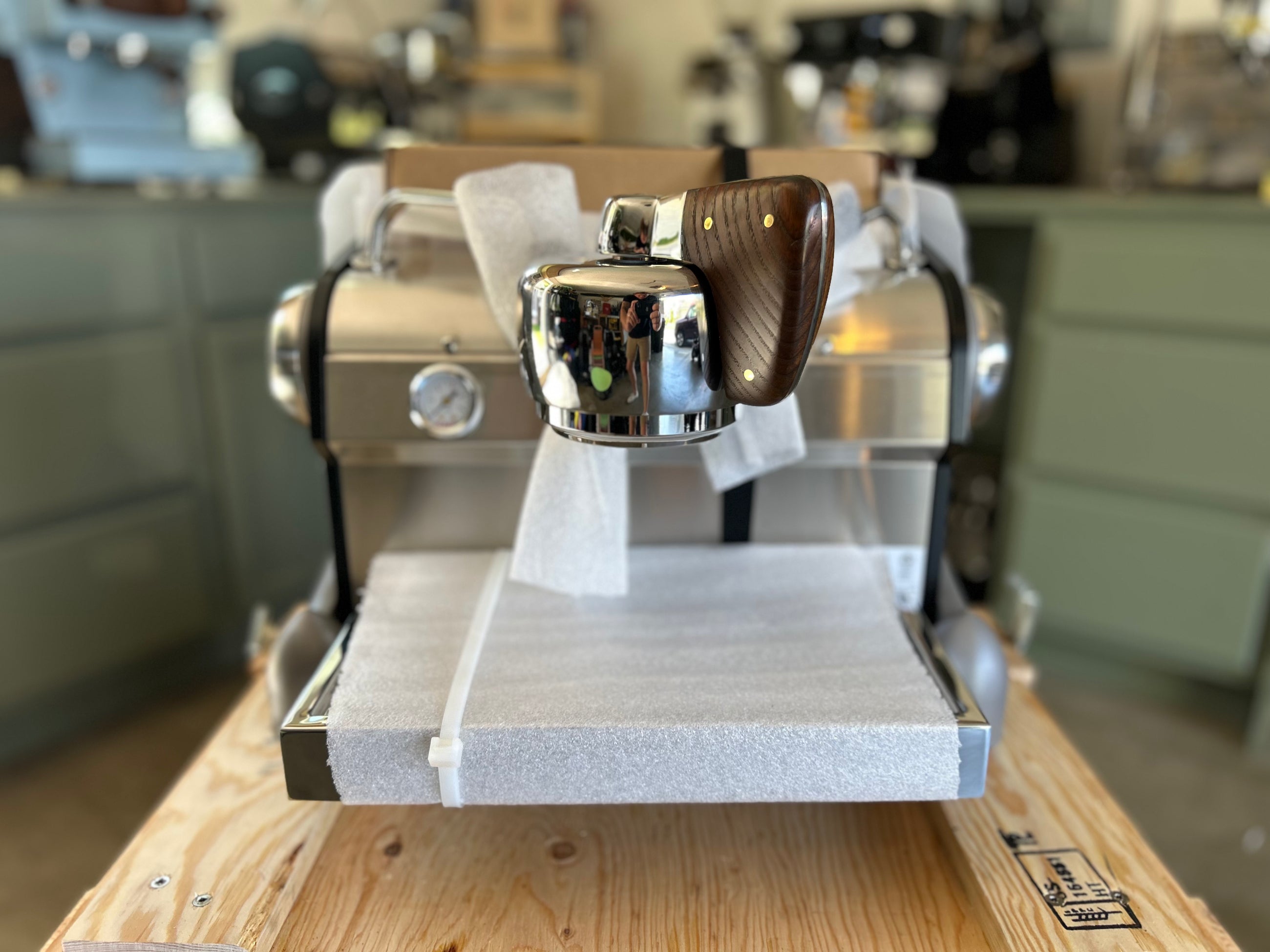 Slayer Espresso Single on a wooden counter with a blurred background