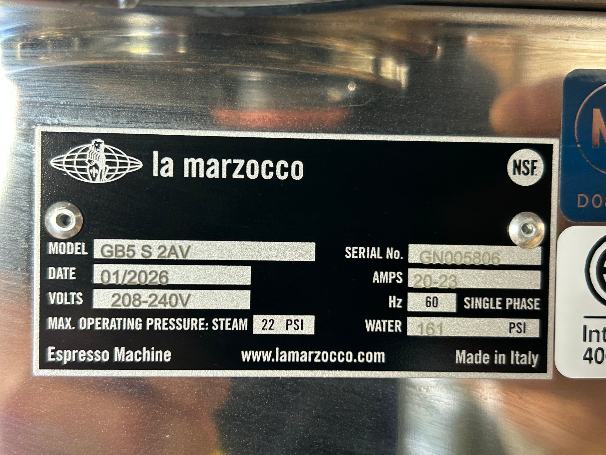La Marzocco espresso machine label with model details.