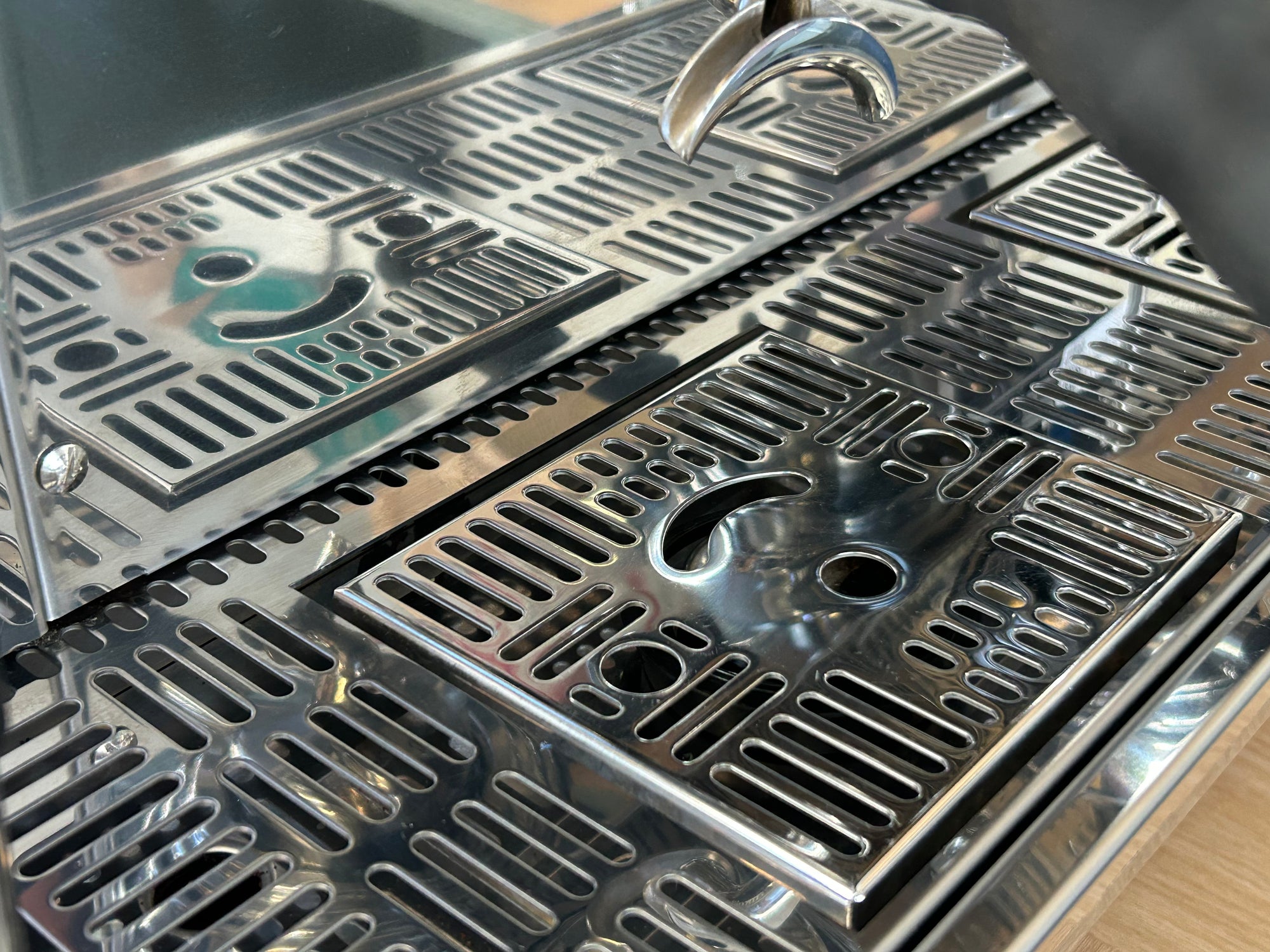 Close-up of a metallic grill with a textured surface