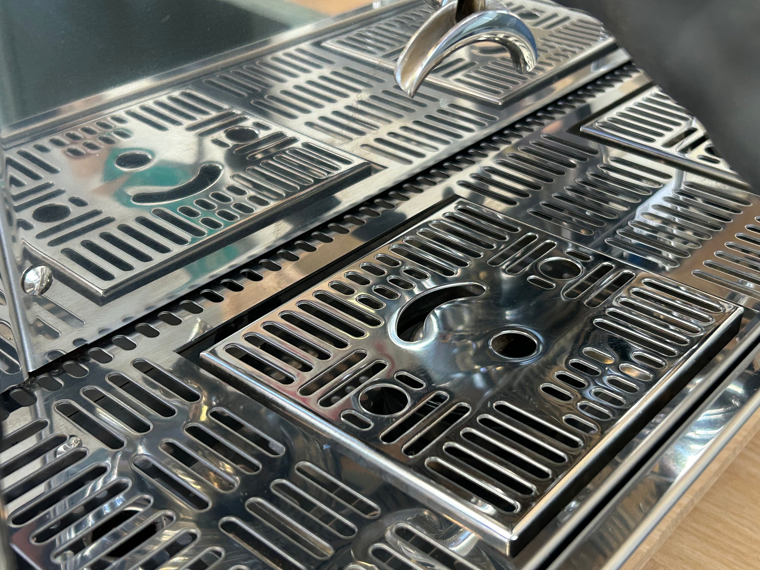 Close-up of a metallic grill with a textured surface