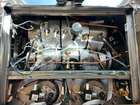 Close-up of a mechanical system with various components and wiring inside an GB5 ABR espresso machine