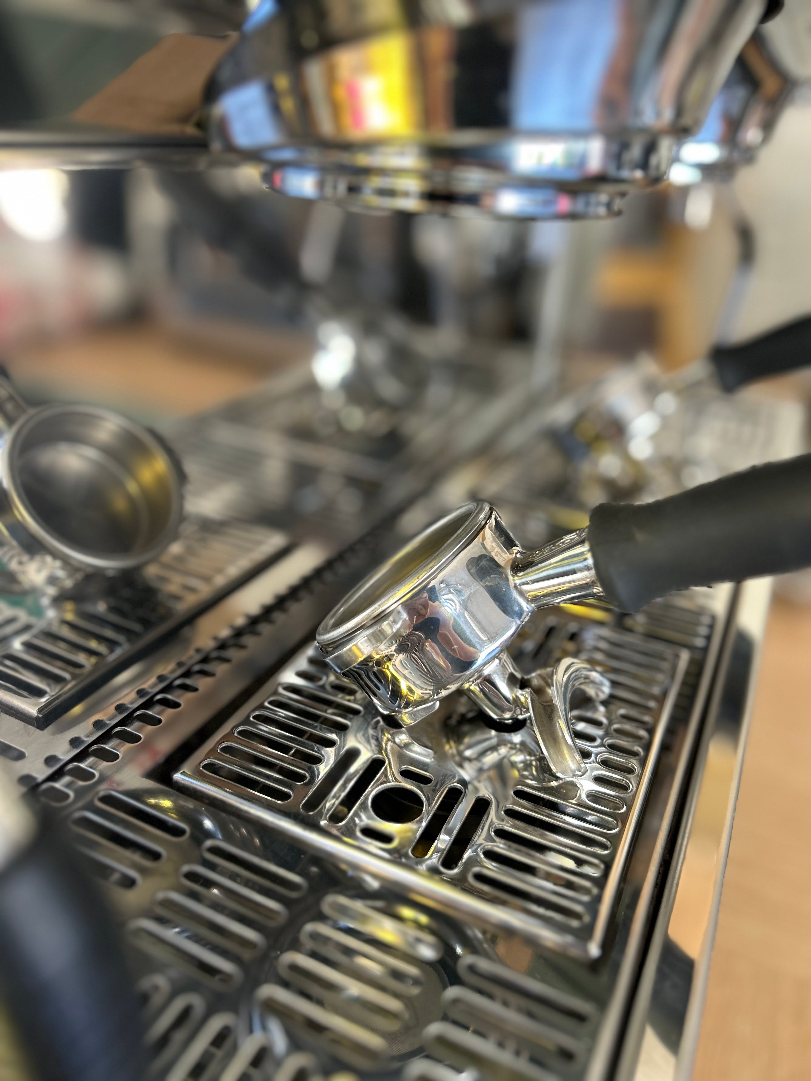 Close-up of a coffee machine with a focus on the portafilter.